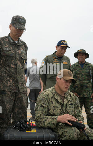 Stati Uniti Navy Builder di 2a classe di Sean McHugh, assegnato alla costruzione subacquea Team 2, comanda un Seabotix veicolo azionato in modo remoto come comandante, Repubblica di Corea Flottiglia del componente 5, posteriore Adm. Cantato Ryol Lee e comandante, Royal Thai Navy l'eliminazione degli ordigni esplosivi, Chaiwut Aiemsri, guarda su in Sattahip, Tailandia per esercitare Cobra Gold Feb 19, 2018. Cobra Oro 18 fornisce una sede per gli Stati Uniti, alleati e nazioni partner di anticipo di interoperabilità e di aumentare la capacità del partner nella pianificazione ed esecuzione di complesse e realistica forza multinazionale e combinate task force operazioni. Foto Stock