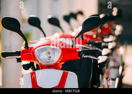 Close Up di manubri di molte moto elettrica, motociclette Scooter parcheggiati in fila nella strada della citta'. Foto Stock