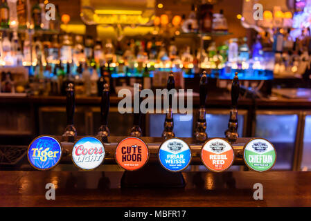 La birra rubinetti e pompe in un bar di notte. Foto Stock