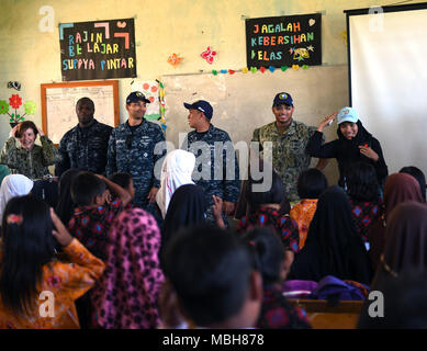 Indonesia (5 aprile 2018) velisti assegnati ai militari di comando Sealift nave ospedale USNS misericordia (T-AH 19) e un insegnante da SD 77 elementari di cantare con gli studenti. La misericordia è attualmente implementata in supporto Partnership Pacifico 2018 (PP18). PP18's missione è lavorare collettivamente con host e nazioni partner per migliorare l'interoperabilità a livello regionale di emergenza e capacità di risposta, aumentare la stabilità e la sicurezza nella regione e favorire la nascita di nuove e durature amicizie in tutta la regione Indo-Pacifico. Pacific Partnership, ora nel suo tredicesimo iterazione, è la più grande multinazionale annuale assistan umanitario Foto Stock