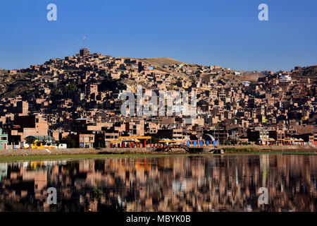 Città di Puno riflettendo sul lago Titicaca in Perù Foto Stock