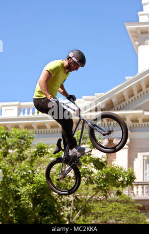 Atene, GA, Stati Uniti d'America - 26 Aprile 2014: un giovane uomo di pratica con la sua rampa salta al BMX Trans Jam la concorrenza sulle strade del centro di Atene. Foto Stock