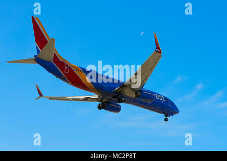 Southwest Airlines Boeing 737 jet del passeggero sulla approccio finale all'Aeroporto Internazionale di Los Angeles LAX, California, Stati Uniti d'America. La luna in vista di byte di overhead. Foto Stock