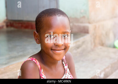 Lugazi, Uganda. 14 maggio 2017. Un ritratto di una bella ragazza ugandese seduta sulle scale di fronte a una casa. Foto Stock