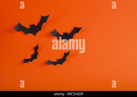 I pipistrelli volare su sfondo arancione con spazio per il design. Concetto di Halloween. Foto Stock