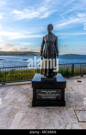 Statua di Markiza Anna Bugeja con vedute di St Pauls Bay, Bugibba, Malta, Europa Foto Stock