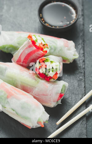 Asian freschi involtini primavera. Materie il cetriolo, la carota e la lattuga, peperone, tofu formaggio all'interno di carta di riso. Il concetto di sano e cibo vegan. Foto Stock