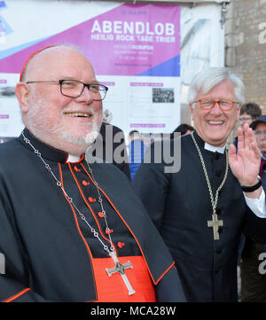 14 aprile 2018, Germania, Treviri: il Cardinale Reinhard Marx (L) e Heinrich Bedford-Strohm (Presidente del Consiglio della Chiesa Evangelica in Germania) Scherzo intorno al di fuori della cattedrale durante la fase di apertura dell'nationwide 'Woche fuer das Leben" (lit. La Settimana per la vita) delle due grandi chiese cristiane. Il motto della campagna per la tutela e la dignità delle persone dall'inizio della loro vita alla sua estremità è 'Kinderwunsch. Wunschkind. Unser tipo!' (lit. Il desiderio di avere figli. previsto bambino. Il nostro bambino!!!). Foto: Harald Tittel/dpa Foto Stock