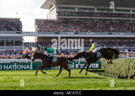 Corridori e cavalieri al Randox Health Grand National, Aintree, Liverpool, Merseyside. 14th aprile 2018. I cavalli e i cavalieri Grand National corrono sopra la recinzione di salto in acqua della tribuna. Foto Stock