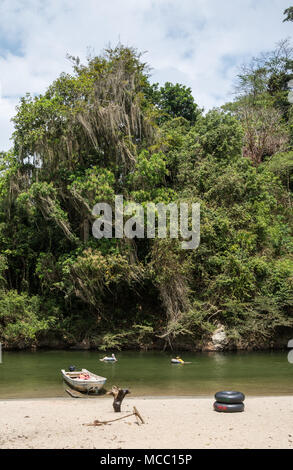 Famiglia turistico il tubo lungo un fiume di lussureggiante foresta verde. La Colombia, Sud America. Foto Stock