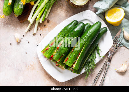 Tradizionale Coreano Kimchi alimentare (cetriolo). I cetrioli marinati con ripieno di verdure (Sweet Pepper, aglio, cipolla, verdi, il concentrato di pomodoro) su una pietra o Foto Stock