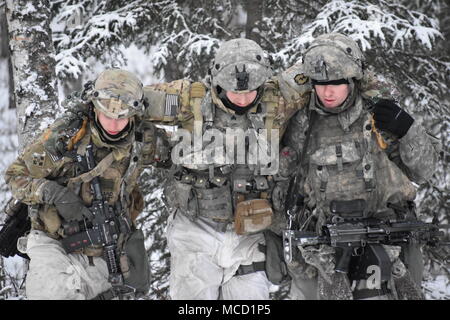 I soldati assegnati a società di caricabatterie, 1° Battaglione, quinto reggimento di fanteria, 1° Stryker Brigade Combat Team, XXV divisione di fanteria, U.S. Esercito di Alaska, spostare una simulazione di incidente dopo assaltando un obiettivo durante il funzionamento conca a base comune Elmendorf-Richardson, Alaska, il 10 febbraio, 2018. Funzionamento Conca è stato un battaglione-livello, bracci combinata live esercitazione antincendio che si è concentrato sulla costruzione di prontezza e letalità artico attraverso la dura e addestramento realistico. Durante il funzionamento di tre aziende contemporaneamente manovrato attraverso vari terreni; attaccando e cogliendo le posizioni nemiche come pure e Foto Stock