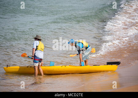 Due uomini con i loro ocean kayak di mare barca su Avalon Beach a Sydney, Australia Foto Stock