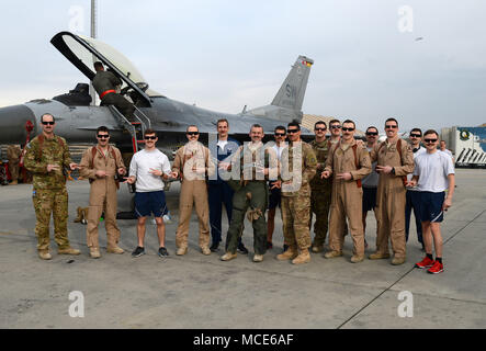 "Mach" (centro), 77th Expeditionary Fighter Squadron F-16 Fighting Falcon pilota da caccia, posa per una foto con i membri dalla 77th EFS Febbraio 28, 2018 a Bagram Airfield, Afghanistan. "Mach" ha ricevuto una "Double Down" benvenuto dal "Gamblers" come egli ha superato i 1.000 contro-ora pietra miliare nell'F-16 Fighting Falcon. (U.S. Air Force foto/Staff Sgt. La divina Cox) Foto Stock