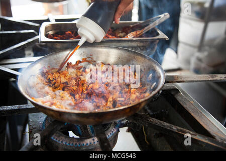 Cerdo adobado y arroz frito con kimchi (carne di maiale adobada con kimchi riso fritto) essendo cotti Don Ramen, Telefónica Gastro Park Tijuana, Baja California, Foto Stock