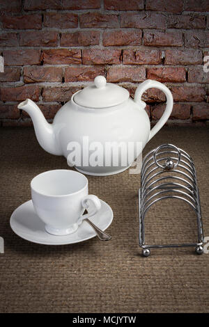 Teiera, toast rack e tazza e piattino Foto Stock