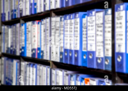 Scena sfocata di scaffali pieni di carta e documenti memorizzati in un vecchio archivio. Foto Stock