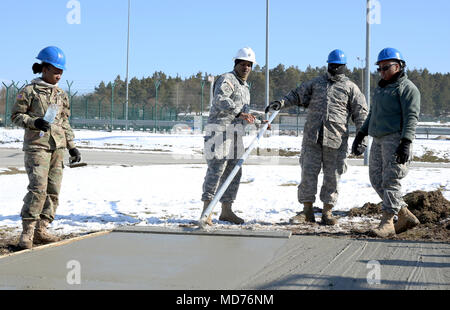 Un membro senior del tecnico 859th Company, Mississippi Esercito Nazionale Guardia, incarica altri soldati con opportune tecniche di lisciatura del calcestruzzo che assomiglierà presto finito di soletta in calcestruzzo. La bramma diventerà la fondazione in calcestruzzo sotto il gazebo. Questi soldati hanno trascorso la loro formazione annuale presso la multinazionale comune disponibilità del Centro di formazione Hohenfels Area, Hohenfels, Germania, la costruzione di diversi progetti di costruzione in marzo 11 - 31. Per molti dei giovani soldati questa è la prima volta che lavoro con concreta dopo la loro iniziale militare di abilità professionali formazione. (Brevetto statunitense n. Foto Stock