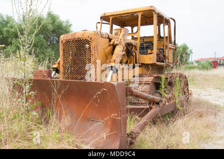 Vecchio abbandonato bulldozer a sinistra per la ruggine in un campo Foto Stock