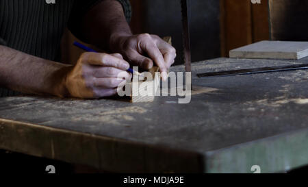 Carpenter misure e segna la linea di taglio utilizzando un falegname righello Foto Stock