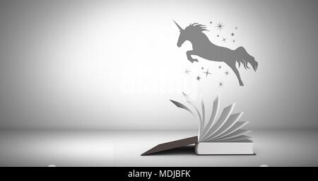 Unicorn silhouette volando sul Libro magico Foto Stock