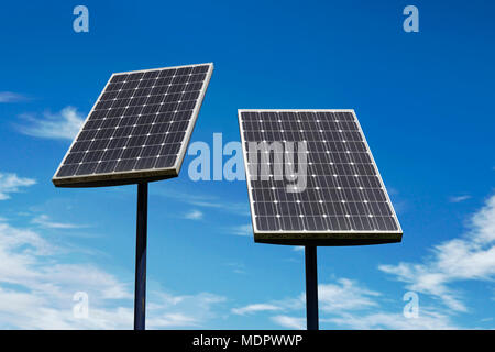 Piccoli pannelli solari contro un cielo blu Foto Stock