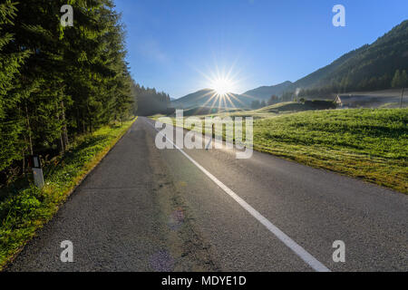 Mattina sole che splende sulla strada di campagna a Braies Dolomiti in provincia di Bolzano (Alto Adige), Italia Foto Stock