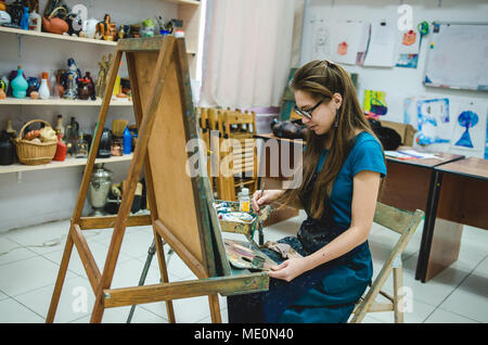 Pittore femmina disegno in art studio con cavalletto Foto Stock