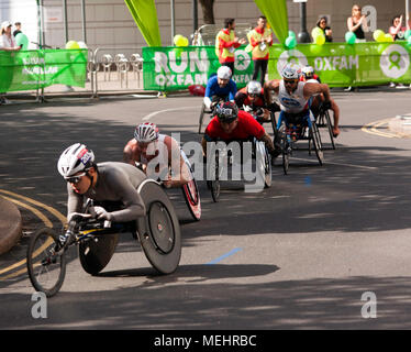 Il Mens Elite atleti su sedia a rotelle passano attraverso Cabot Square, Canary Wharf, a 18 miglia durante il 2018 maratona di Londra. David Wier (casco nero) è andato a vincere gli uomini di razza in sedia a rotelle in un tempo di 01.31.15. Foto Stock