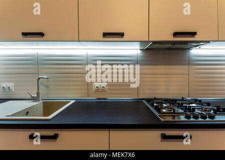 Nuovo incredibile contemporanea cucina in legno con forno moderno e lavello con rubinetto di acqua. Foto Stock