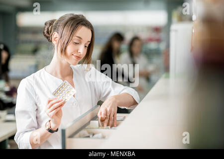 Il farmacista che lavorano in farmacia store Foto Stock
