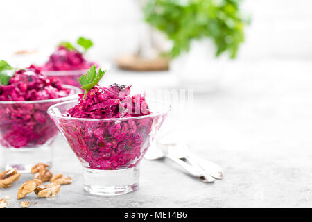 Insalata di barbabietole. Insalata di bollito di barbabietole. La barbabietola rossa con insalata di potare le noci e la panna acida su sfondo bianco Foto Stock