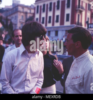 Beatle George Harrison mit Patricia Anne tortino Boyd im Gespräch mit Rennfahrer Jim Clark bei einem Besuch in Monte Carlo, Monaco 1966. Beatle George Harrison e Patricia Anne tortino Boyd parlando a racing driver Jim Clark durante la visita a Monte Carlo, Monaco 1966. Foto Stock