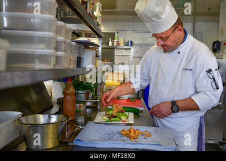 Archiviato - 08 marzo 2018, Germania, Brema e Bremerhaven: Dominik Flettner, capo chef dell'Atlantic Hotel Sail City, sorge nella sua cucina prepara il cibo. Flettner è consapevole di produrre come littell rifiuti come possibile nella sua cucina e utilizza potatoe bucce, ad esempio per friggere deliziosa potatoe chips come insalata sidedish. Egli è un membro del " Regno contro rifiuti" campagna. Foto: Karsten Klama/dpa Foto Stock