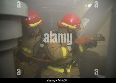 171028-N-DO281-053 OCEANO ATLANTICO (ott. 28, 2017) marinai contro un incendio durante un quartier generale (GQ) praticare, a bordo guidato-missili cruiser USS Monterey (CG 61), 28 ottobre 2017. Il Monterey è distribuito a sostegno della sicurezza marittima le operazioni negli Stati Uniti la quinta e la sesta flotta area di operazioni (U.S. Foto di Marina di Massa Specialista comunicazione marinaio Trey Fowler). () Foto Stock