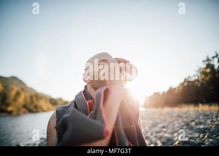 Canada, British Columbia, Chiliwack, uomo di bere dalla possibile al fiume Fraser Foto Stock