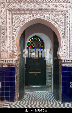 Ornati in stile moresco marocchino arco a ferro di cavallo porta nei souks, Marrakech, Marocco Foto Stock