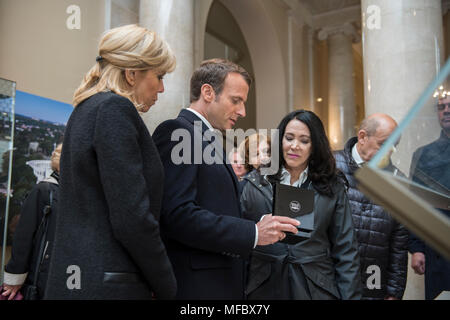 Il Presidente francese Emmanuel Macron (al centro) con sua moglie Brigitte Macron (sinistra), presenta un dono per Karen Durham-Aguilera (a destra), direttore esecutivo, Esercito Nazionale i cimiteri militari, nel memoriale Anfiteatro Sala di visualizzazione presso il Cimitero Nazionale di Arlington Arlington, Virginia, 24 aprile 2018. Presidente Macron la visita al Cimitero Nazionale di Arlington fu parte del primo ufficiale di visita di Stato dalla Francia dal Presidente François Hollande è venuto a Washington nel 2014. Il Presidente francese insieme a sua moglie ha anche visitato il recinto dell ex Presidente John F. Kennedy. (U.S. Esercito foto di di eliz Foto Stock