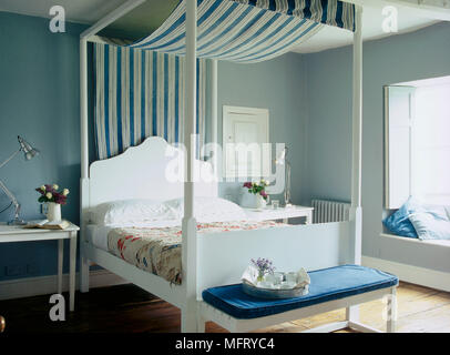 Un blu pallido paese camera da letto con una tavola di legno dipinto di letto a baldacchino con un tessuto a righe cielino Foto Stock