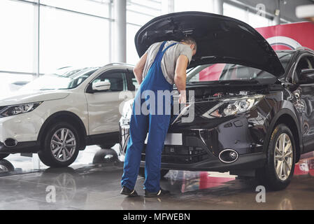 Immagine che mostra la muscolare auto lavoratore servizio di riparazione veicolo Foto Stock
