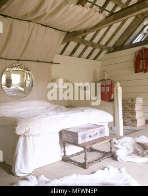 Letto matrimoniale in stile rustico, camera da letto con soffitto con travi a vista Foto Stock