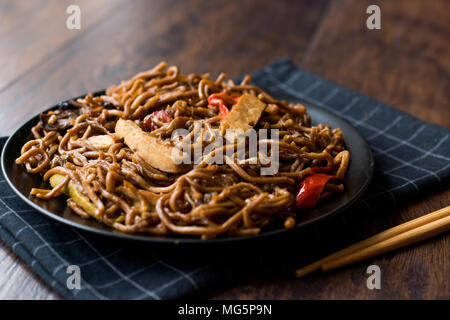 Veggie Noodle con tofu e peperoni rossi sulla piastra nera. I cibi tradizionali. Foto Stock