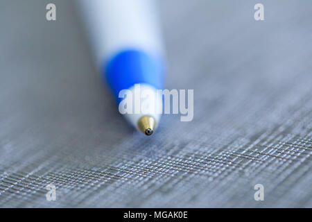 Penna a sfera in foto macro tasto su sfondo di fantasia. Close up focalizzata sulla parte superiore della sfera della penna. Primo piano di una penna a sfera, la profondità di campo Foto Stock