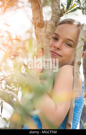 Ragazzina e albero di olivo Foto Stock