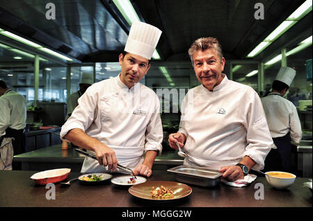 Tre-starred chef Régis Marcon (a destra) al lavoro con il suo figlio Jacques (sinistra) nella cucina del suo ristorante a Saint-Bonnet-le-froid, Francia Foto Stock