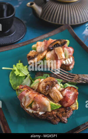 Deliziosi toast di avocado e prosciutto con verde senape germogliato. Una sana prima colazione. Copiare lo spazio. Foto Stock