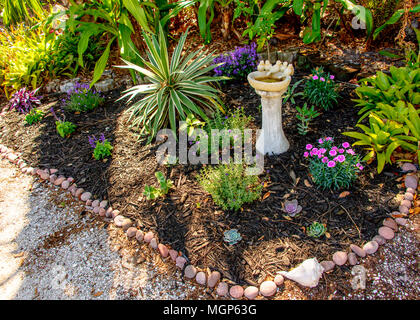 Giardino paesaggistico fiori, rocce e Bagno uccelli Foto Stock