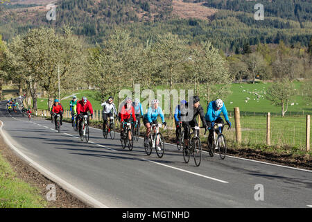 Fort Augustus, Scotland, Regno Unito. Il 29 aprile, 2018. I ciclisti che partecipano all'Etape Loch Ness chiuso il ciclo stradale sportiva a seguito di un 360-grado 66-Mile / 106 km del percorso attorno a Loch Ness, Scozia, in partenza e a Inverness. Questo evento è atteso per attirare 5.600 ciclisti provenienti da tutta la Scozia e il Regno Unito. Migliaia di sterline saranno sollevate dai partecipanti per Macmillan Cancer Support, l'evento ufficiale di carità. Questa immagine mostra i partecipanti di raggiungere il punto di sosta a metà strada vicino a Fort Augustus. Cliff verde/Alamy Live News Foto Stock