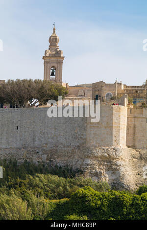 Antica collina fortificata città capitale di Malta, la città silenziosa, Mdina o L-Imdina, skyline contro la molla blu cielo con enormi pareti, cupola della cattedrale Foto Stock