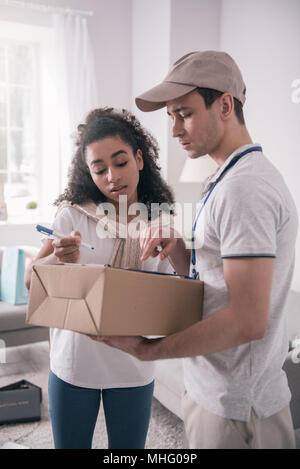 Piacevole guardando bene donna riceve il pacchetto Foto Stock